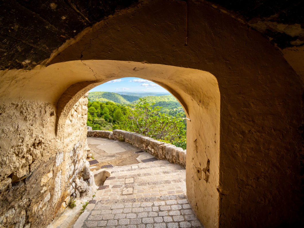 View through a stone arched passage at the medieval hilltop vill